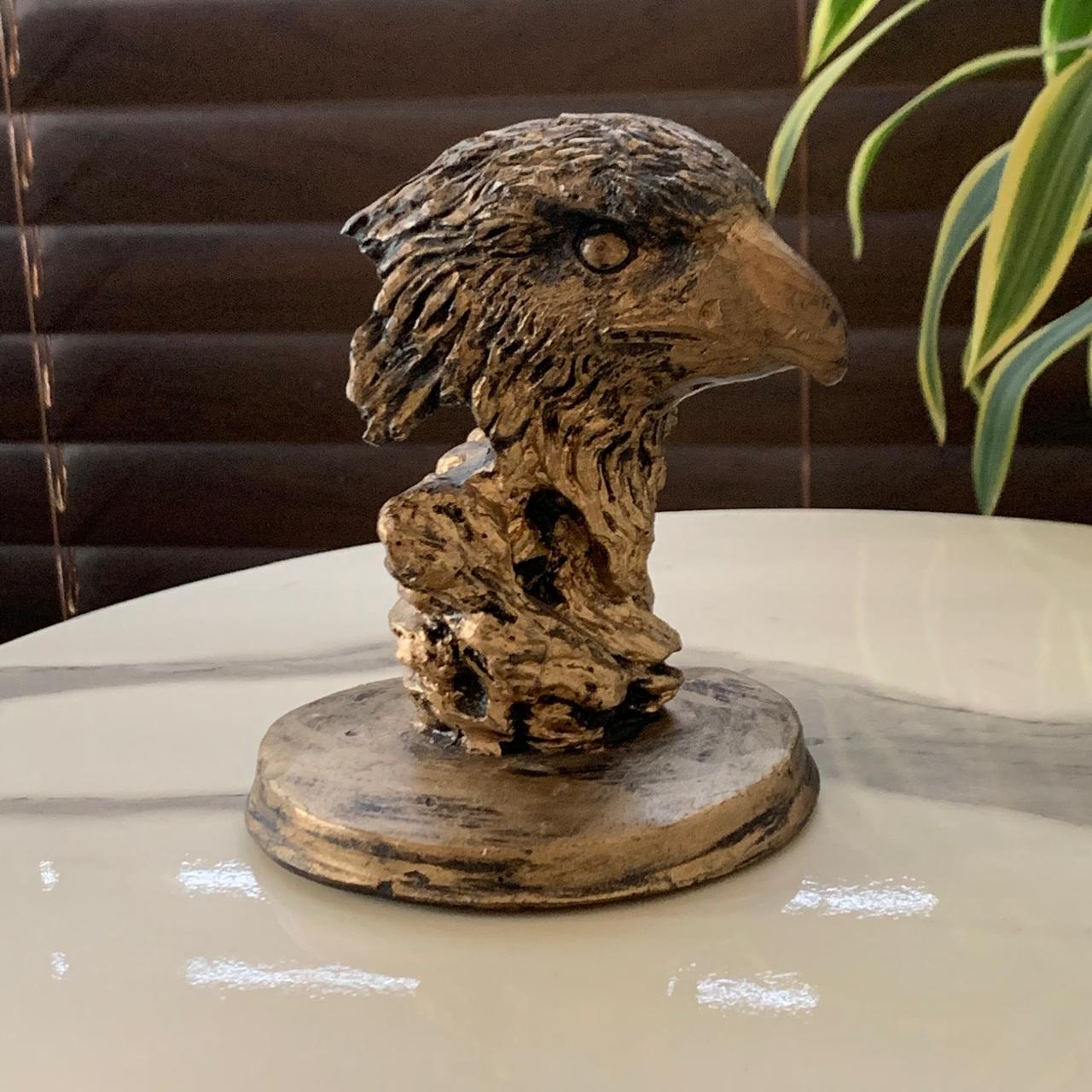 a statue of a bird on a table