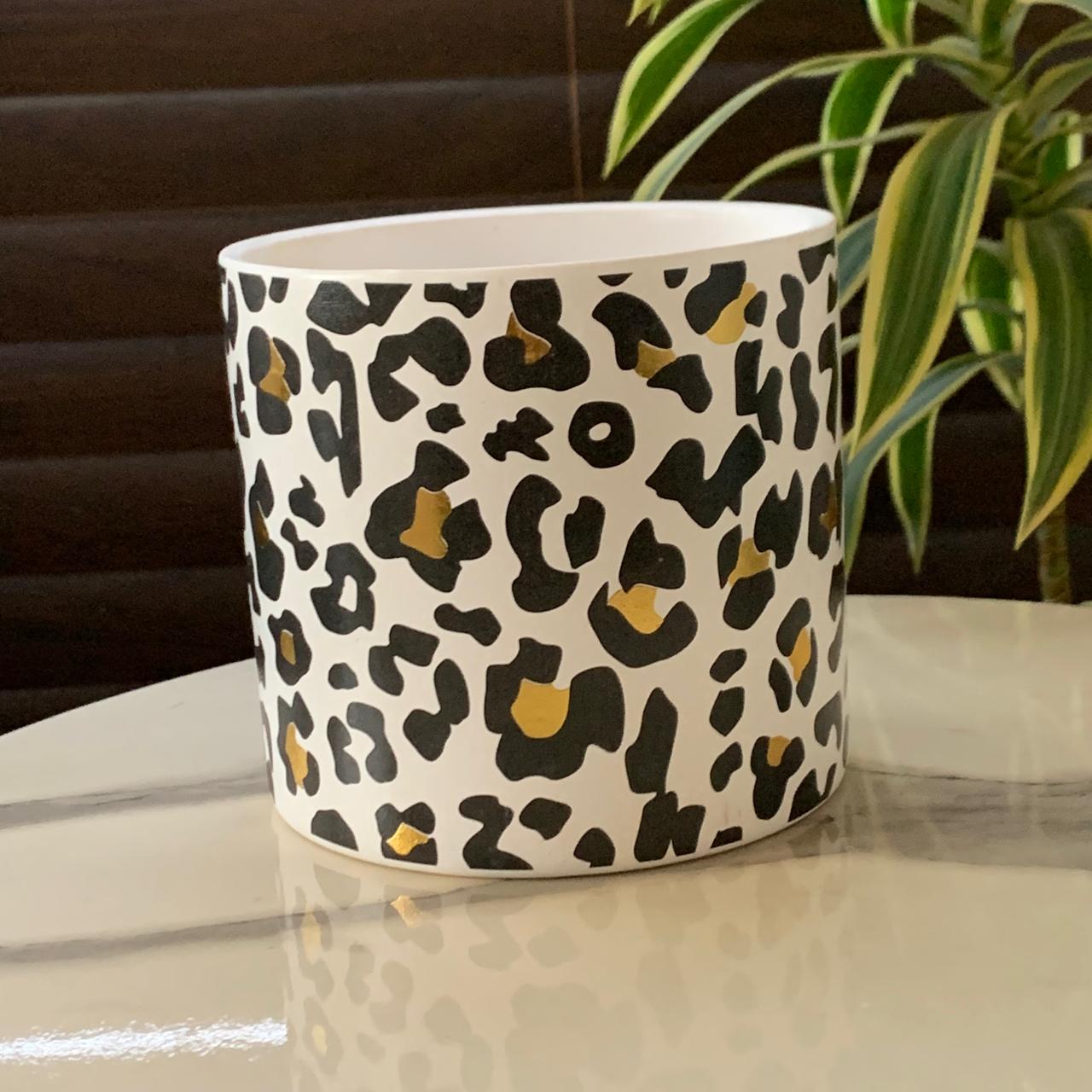a white and black leopard print mug