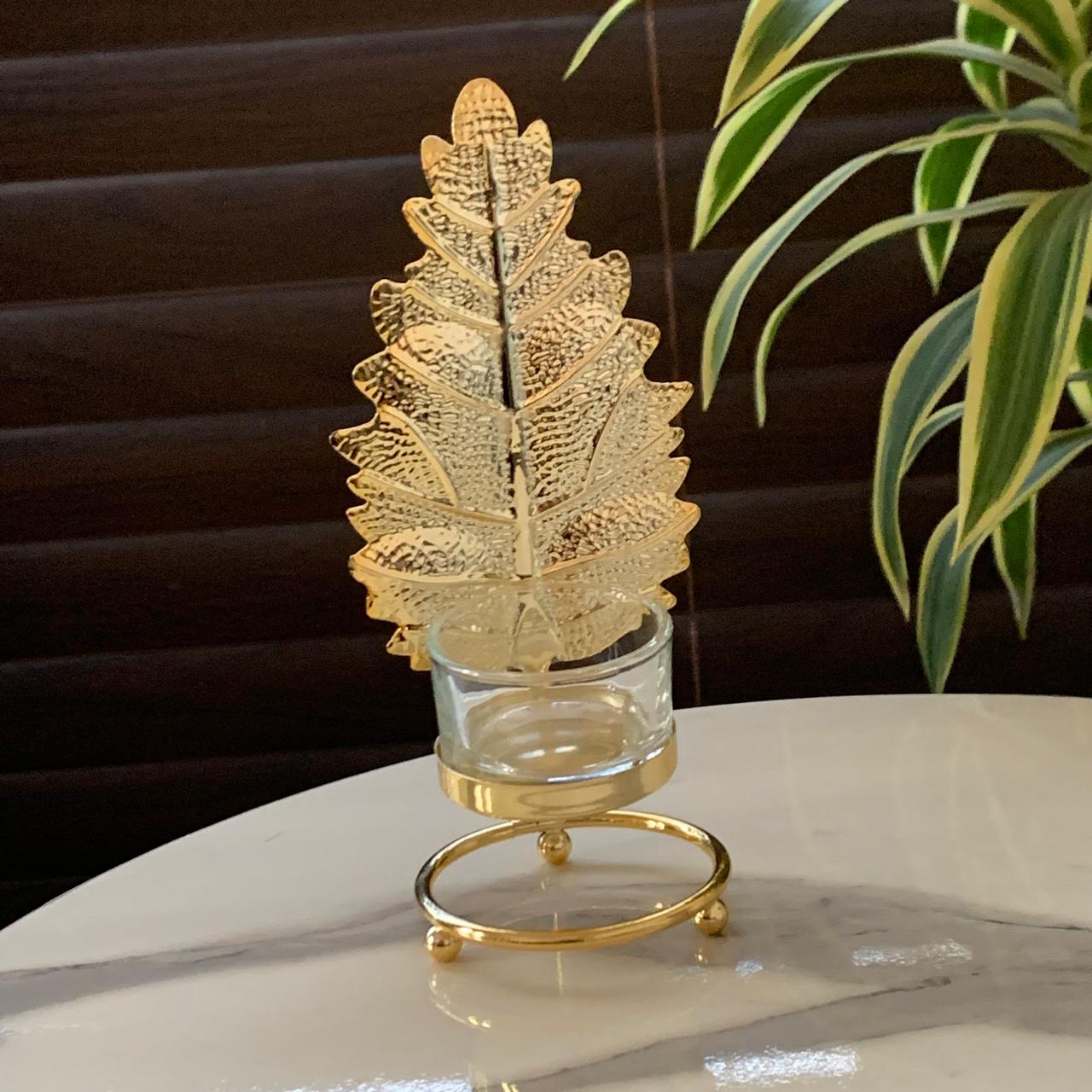 a gold leaf on a glass holder