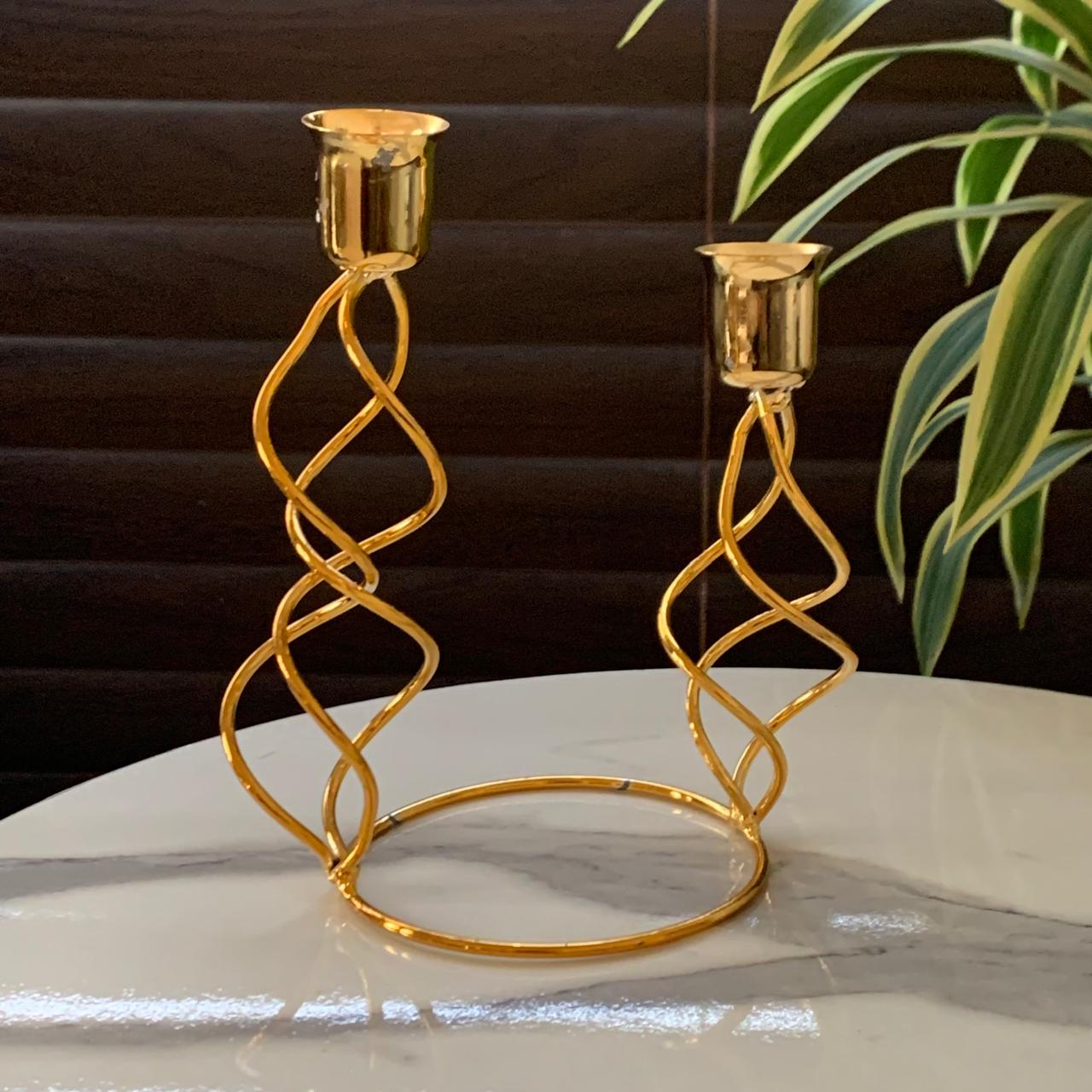 a gold candle holder on a table