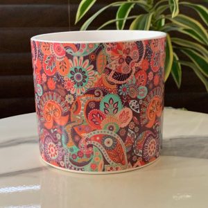 a colorful patterned cup on a marble surface